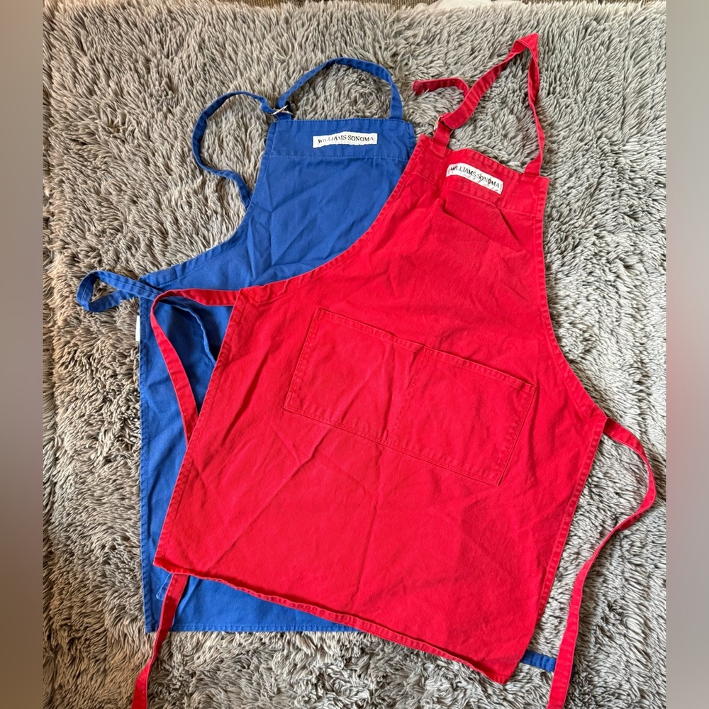 Set of Two Williams-Sonoma cotton bib aprons in red and blue.